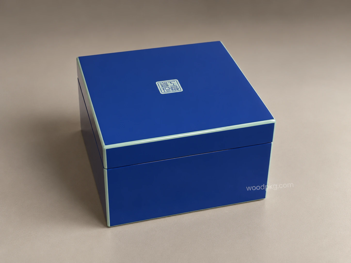 Custom blue high-gloss wooden perfume box with pale green trim and a centered lid logo.