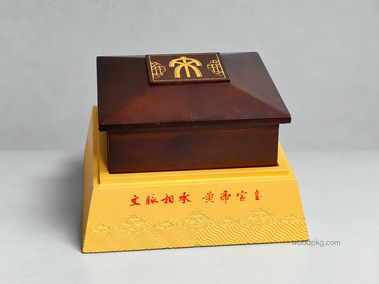 Custom Chinese architecture-inspired wooden display box with a matte rubberwood upper section and a gold-painted base featuring carved traditional Chinese wave motifs.